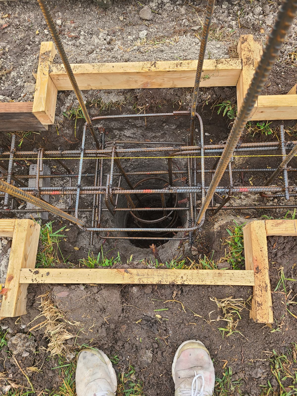 Top view of rebar and pier cage inside footing trench