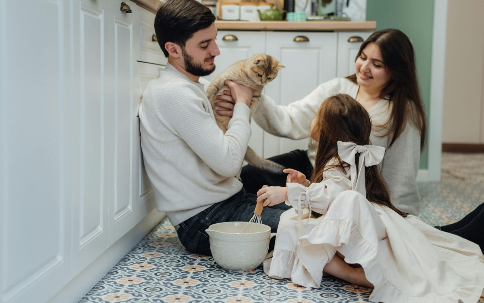 Family enjoying a remodeled kitchen in Houston with island seating and warm lighting